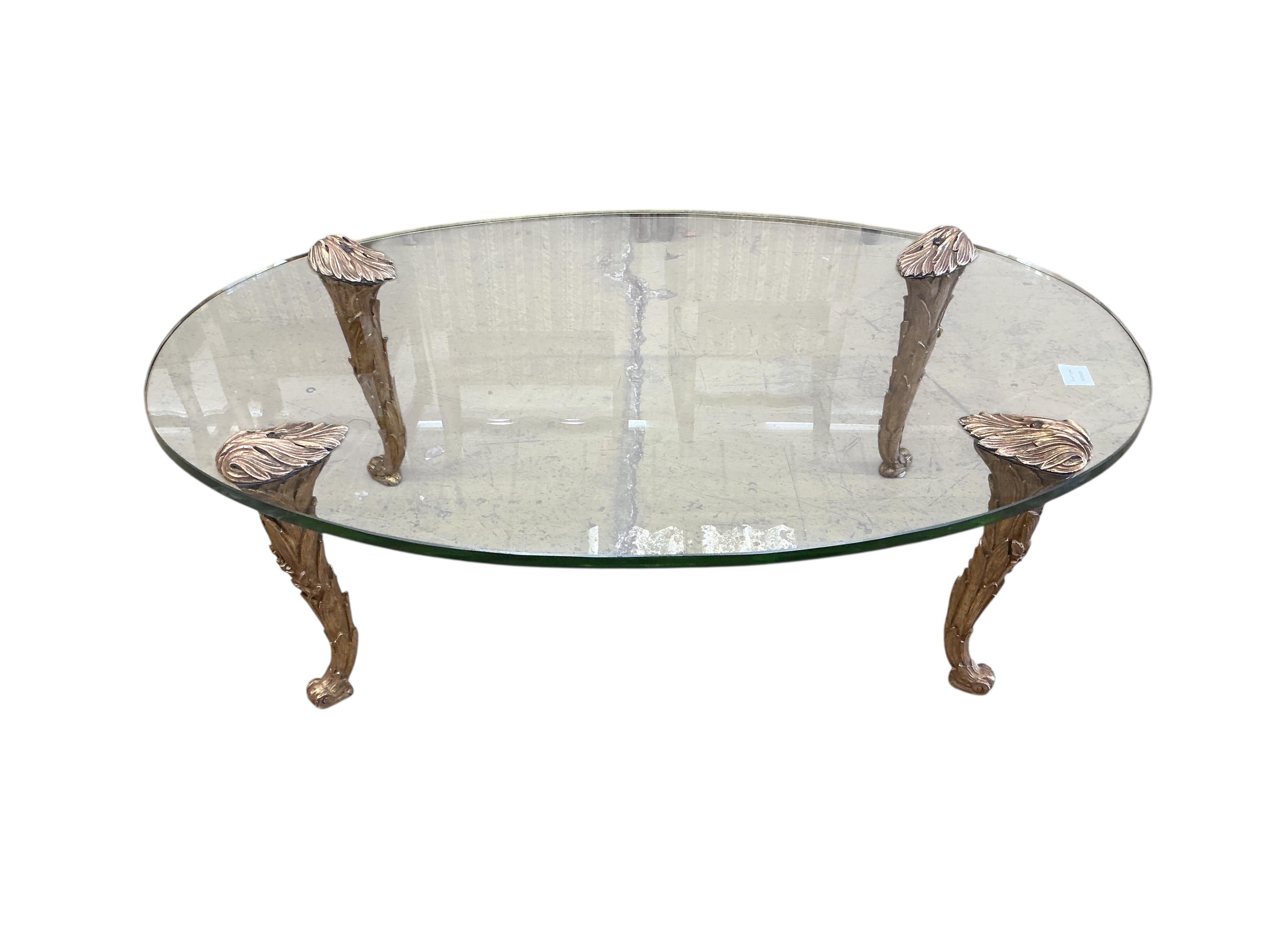A Contemporary oval glass topped coffee table on giltwood legs, width 114cm, depth 72cm, height 38cm